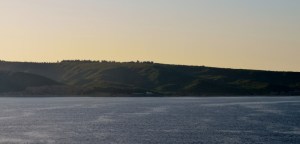 The lone pine tree can just be seen towards the left on top of the hill